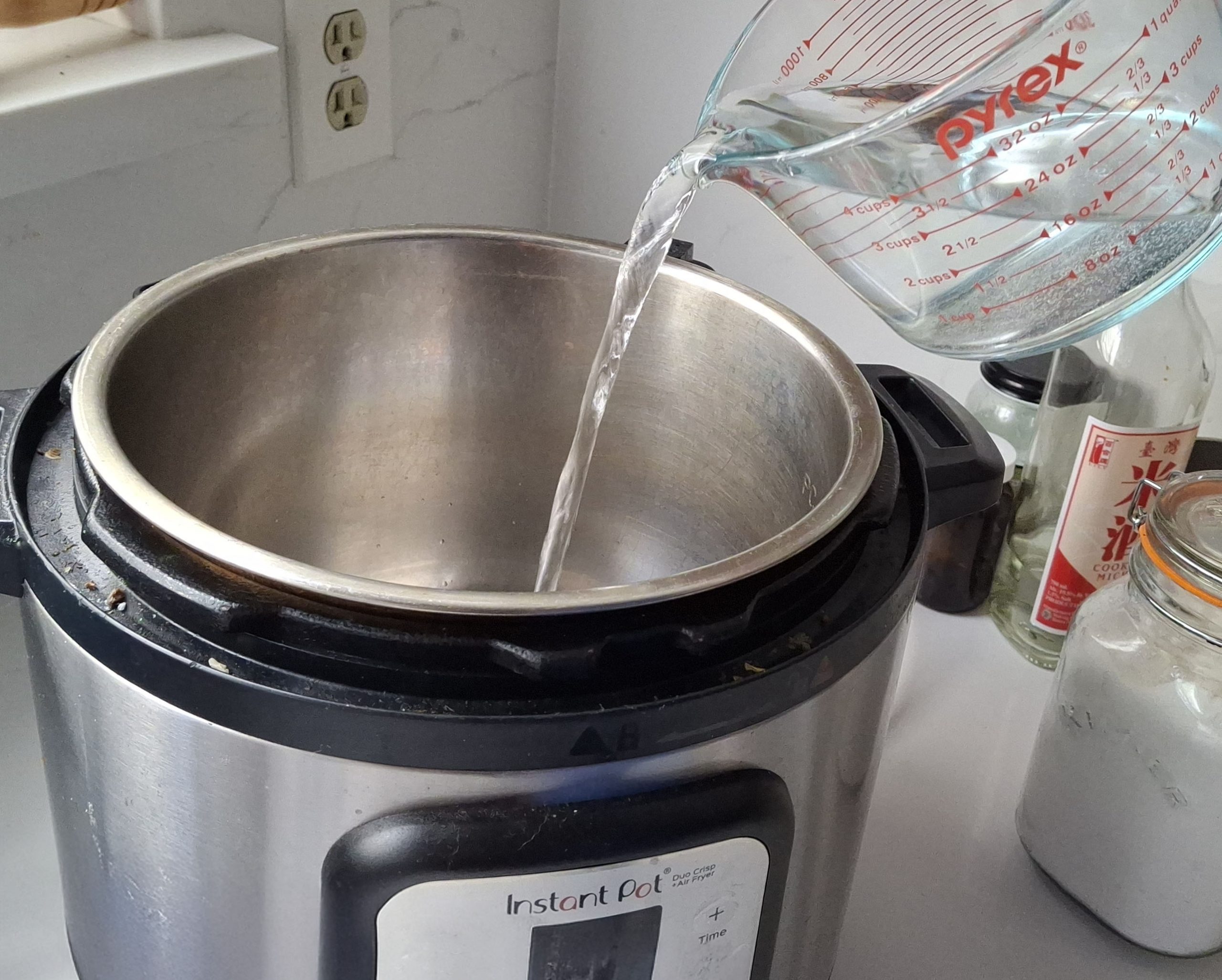 Instant Pot water test setup with one cup of water inside stainless steel inner pot